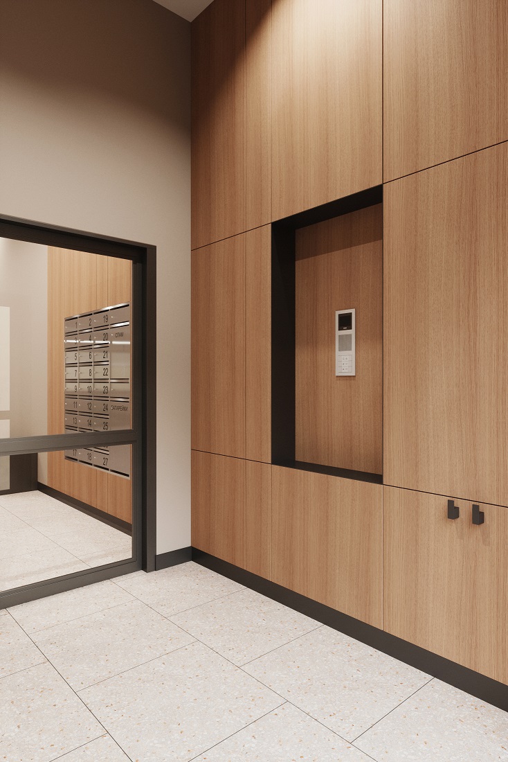 В тамбуре ЖК «Окла» — ниша для сумок рядом с домофоном и крючки для детских колясок В тамбуре ЖК «Окла» — ниша для сумок рядом с домофоном и крючки для детских колясок